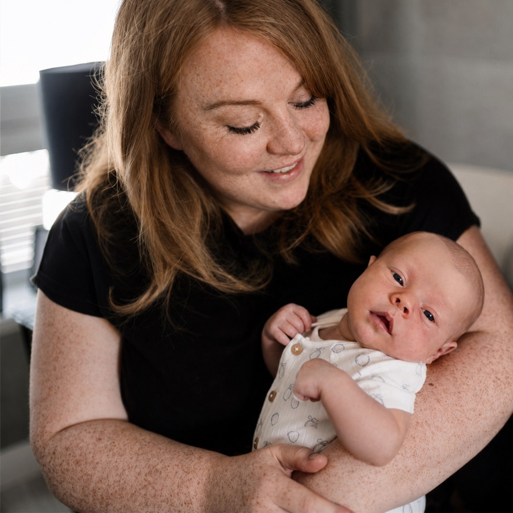 Aimee Taylor, IBCLC lactation consultant and midwife, holding her newborn son